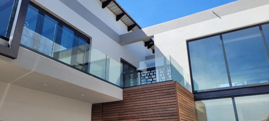 Frameless glass balustrade installed on a modern balcony